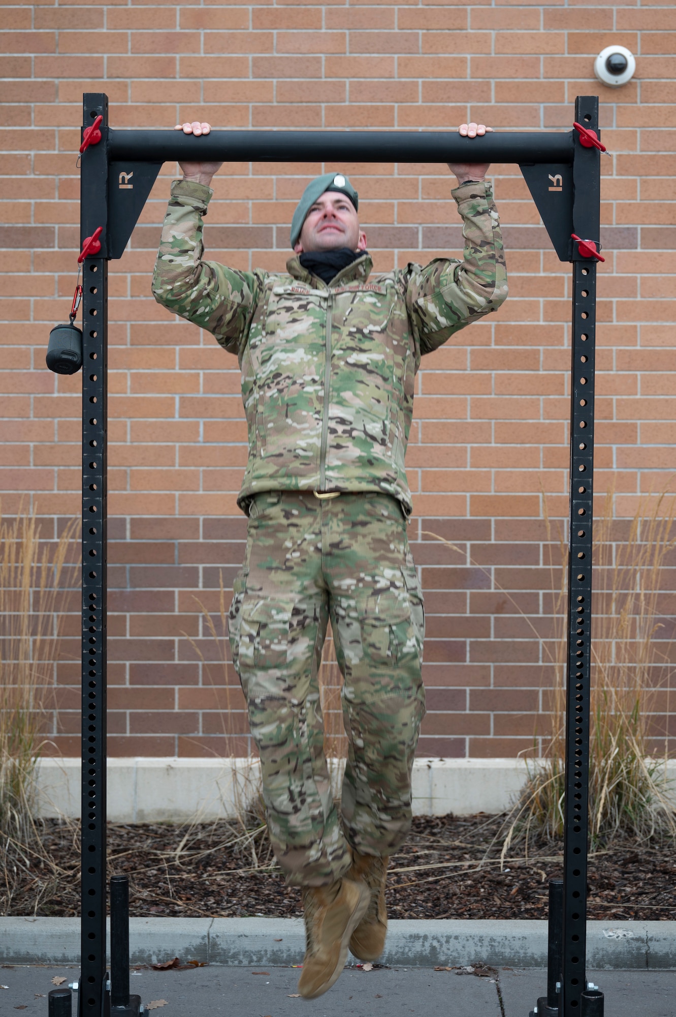An Airman does a pull up.