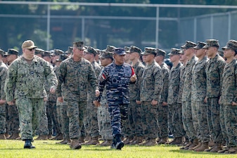 Capt. Tate Robinson, left, USMC Col. Sean Dynan and Indonesian navy Rear Adm. Yoos Suryono Hadi troop the line during the opening ceremony of CARAT Indonesia.
