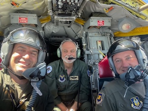 Three airmen smile aboard a B-52