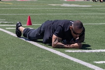 An educator conducts the low crawl portion of the combat fitness test as part of the 2024 Educators Workshop at Marine Corps Recruit Depot San Diego, California, May 7, 2024. Participants of the workshop visited MCRD San Diego from Recruiting Stations Dallas, Fort Worth, Phoenix and San Antonio to observe recruit training and gain a better understanding about the transformation process recruits undergo to become United States Marines. Educators also received classes and briefs on the benefits that are provided to service members in the United States armed forces. (U.S. Marine Corps photo by Lance Cpl. Jacob B. Hutchinson)
