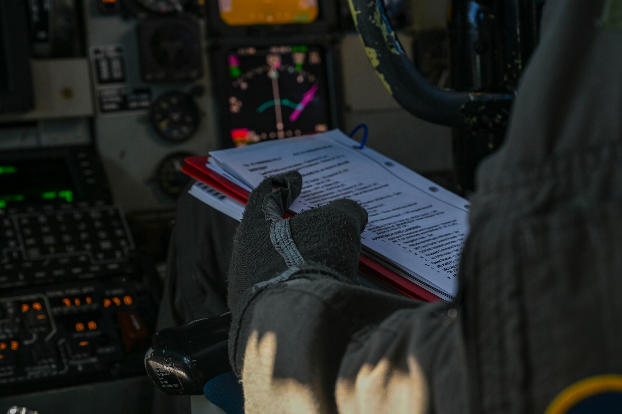 A pilot reads a checklist.