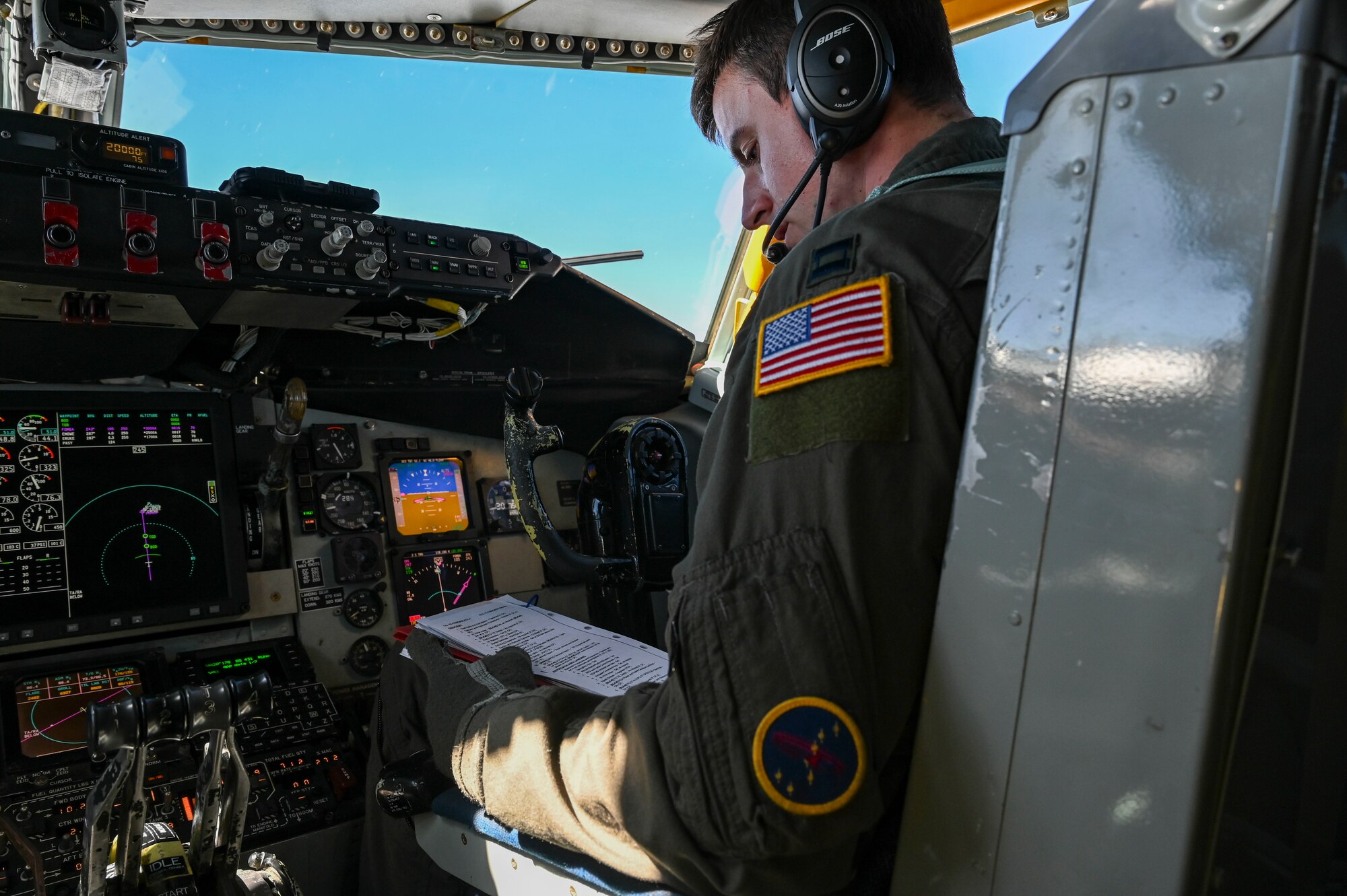 A pilot reads a checklist.