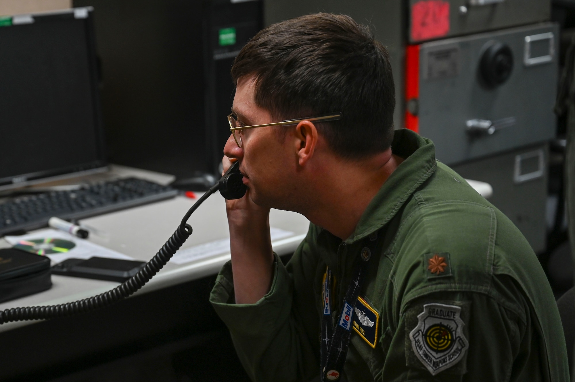 An officer speaks into a portable radio system.