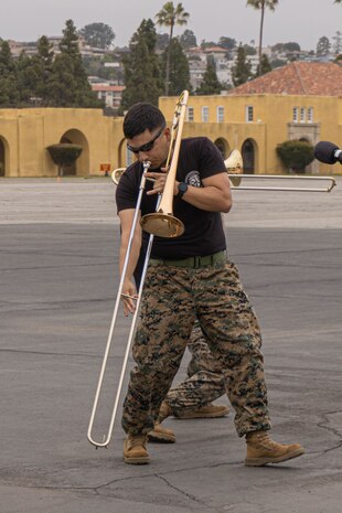 U.S. Marines Corps Sgt. Martin Palacios with Marine Band San Diego performs for the audience during a motivational run at Marine Corps Recruit Depot San Diego, California, May 9, 2024. The motivational run is the final training event new Marines complete before graduating which consists of a three-mile run throughout the Depot. (U.S. Marine Corps photo by Lance Cpl. Alexandra M. Earl)