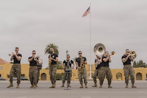 U.S. Marines with Marine Band San Diego perform for the audience during a motivational run at Marine Corps Recruit Depot San Diego, California, May 9, 2024. The motivational run is the final training event new Marines complete before graduating which consists of a three-mile run throughout the Depot. (U.S. Marine Corps photo by Lance Cpl. Alexandra M. Earl)