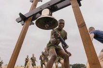A new U.S. Marine with Kilo Company, 3rd Recruit Training Battalion, rings the liberty bell during a motivational run at Marine Corps Recruit Depot San Diego, California, May 9, 2024. The motivational run is the final training event new Marines complete before graduating which consists of a three-mile run throughout the Depot. (U.S. Marine Corps photo by Lance Cpl. Alexandra M. Earl)