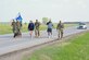 Participants in a National Police Week ruck march walk along a three-mile loop at Ellsworth Air Force Base, South Dakota, May 13, 2024. The ruck began and ended at the Combat Arms Training and Maintenance area and included Airmen and civilians from units across the base. (U.S. Air Force photo by Airman 1st Class Brittany Kenney)