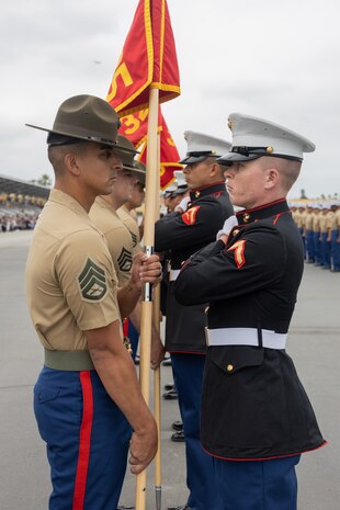 U.S. Marine Corps Staff Sgt. Mario Nunez, a drill instructor with Kilo Company, 3rd Recruit Training Battalion, retires the guidon during a graduation ceremony at Marine Corps Recruit Depot San Diego, California, May 10, 2024. Graduation takes place at the end of the 13-week transformation process, which includes training for drill, marksmanship, basic combat skills, and Marine Corps customs and traditions. (U.S. Marine Corps photo by Lance Cpl. Janell B. Alvarez)