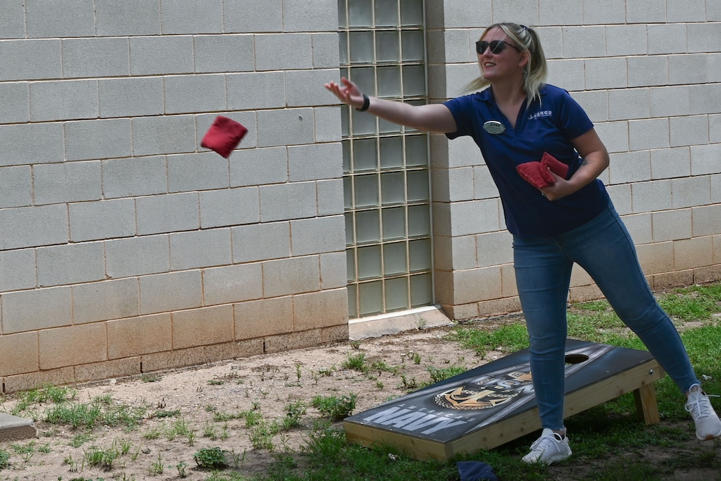 Meredith Balch, 17th Force Support Squadron outdoor recreation director, participates in a game of cornhole at the Powell Event Center, Goodfellow Air Force Base, Texas, May 10, 2024. Goodfellow hosted Military Spouse Resiliency & Wellness Day to provide spouses with resiliency resources, lunch and activities. (U.S. Air Force photo by Airman 1st Class Brian Lummus)