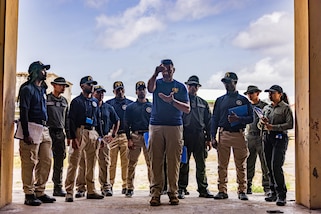 An agent from the FBI Evidence Response Team identifies key crime scene evidence gathering procedures and techniques to Colombian, Guatemalan and Dominican Republic police officers and investigators.