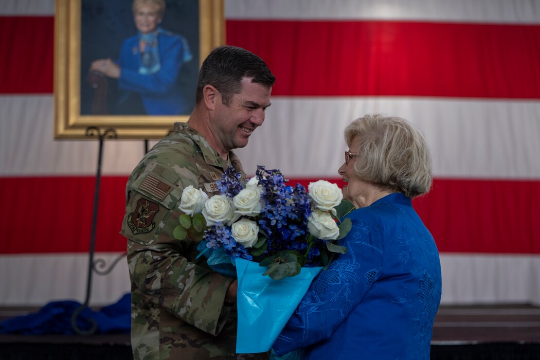 23rd Wing commander hands Dr Lucy a bouquet of flowers