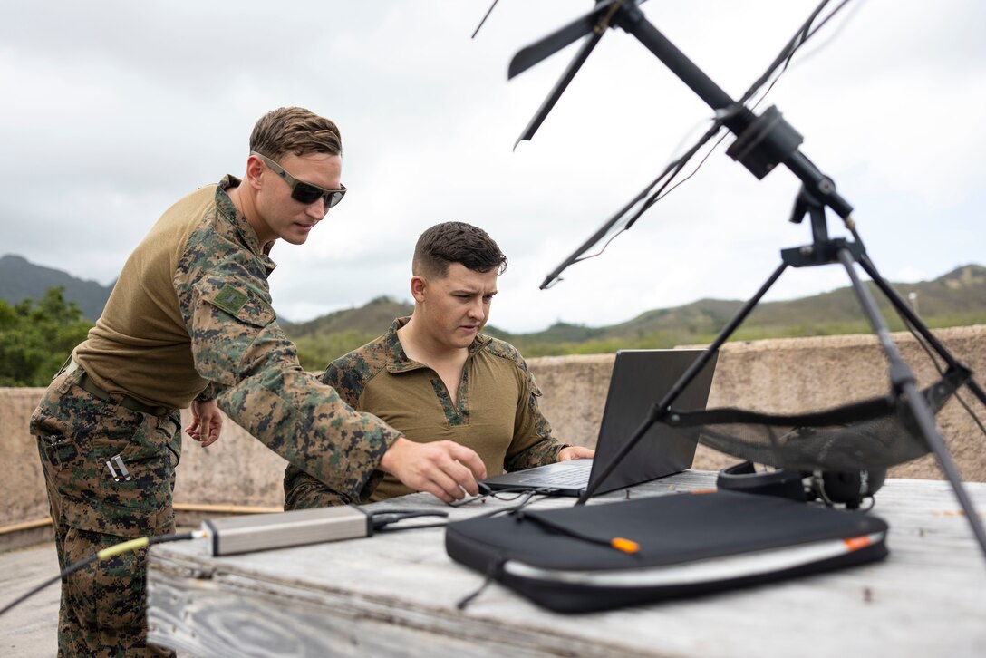 U.S. Marine Corps 1st Lieutenant Andrew Waddell, left, the Officer in Charge of First Platoon, Bravo Company, and Corporal Benjamin Snethen, an electronic warfare analyst, both with 3rd Radio Battalion, III Marine Expeditionary Force Information Group, conduct signals intelligence training operations as part of an Operational Control Element at Bellows Air Force Station, Hawaii on April 8, 2024. The OCE served to test the capabilities of small teams deployed on an island chain to collect enemy signals and movements during exercise Corvus Dawn 24 battalion operations. CD24 sharpened 3rd Radio Battalion's ability to provide technical information related capabilities to III Marine Expeditionary Force and the joint and multi-national force throughout the Indo-Pacific region. 1st Lt Waddell is a native of Indiana. Cpl Snethen is a native of Texas. (U.S. Marine Corps photo by 1st Lt. Tiana Jackson)