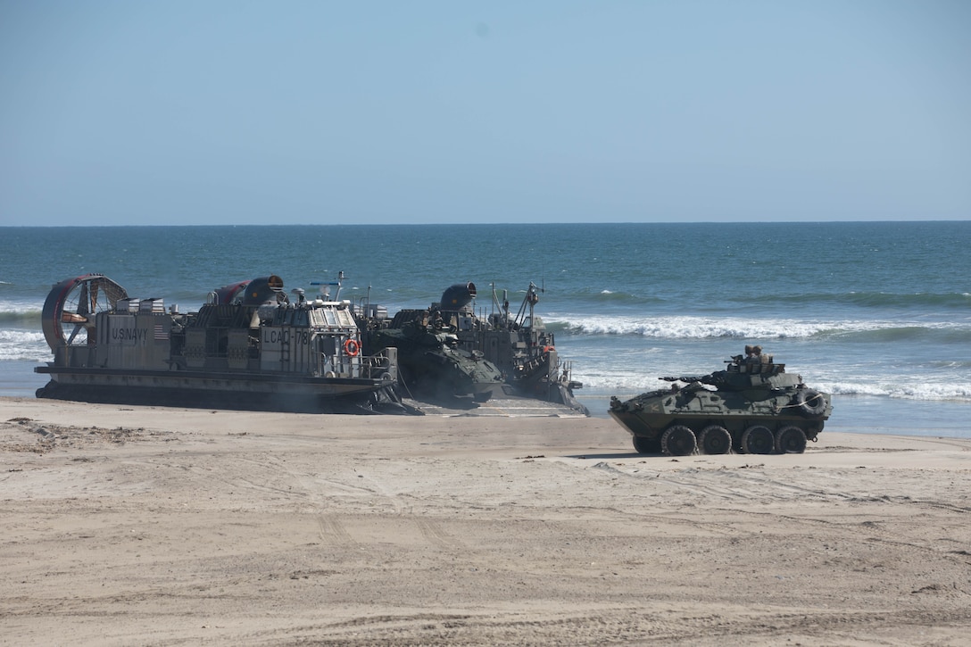 A U.S. Navy landing craft, air cushion hovercraft with Assault Craft Unit 5 brings U.S. Marines with 1st Light Armored Reconnaissance Battalion, 1st Marine Division, ashore at Red Beach as part of a mobile reconnaissance battalion field exercise at Marine Corps Base Camp Pendleton, California, May 6, 2024. The exercise is designed to train Marines with 1st LAR Bn. to deploy as a mobile reconnaissance battalion, which will offer enhanced capabilities that exceed legacy LAR formations as a part of Force Design. (U.S. Marine Corps photo by Cpl. Keegan Jones)