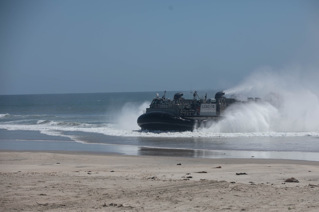 A U.S. Navy landing craft, air cushion hovercraft with Assault Craft Unit 5 brings U.S. Marines with 1st Light Armored Reconnaissance Battalion, 1st Marine Division, ashore at Red Beach as part of a mobile reconnaissance battalion field exercise at Marine Corps Base Camp Pendleton, California, May 6, 2024. The exercise is designed to train Marines with 1st LAR Bn. to deploy as a mobile reconnaissance battalion, which will offer enhanced capabilities that exceed legacy LAR formations as a part of Force Design. (U.S. Marine Corps photo by Cpl. Keegan Jones)