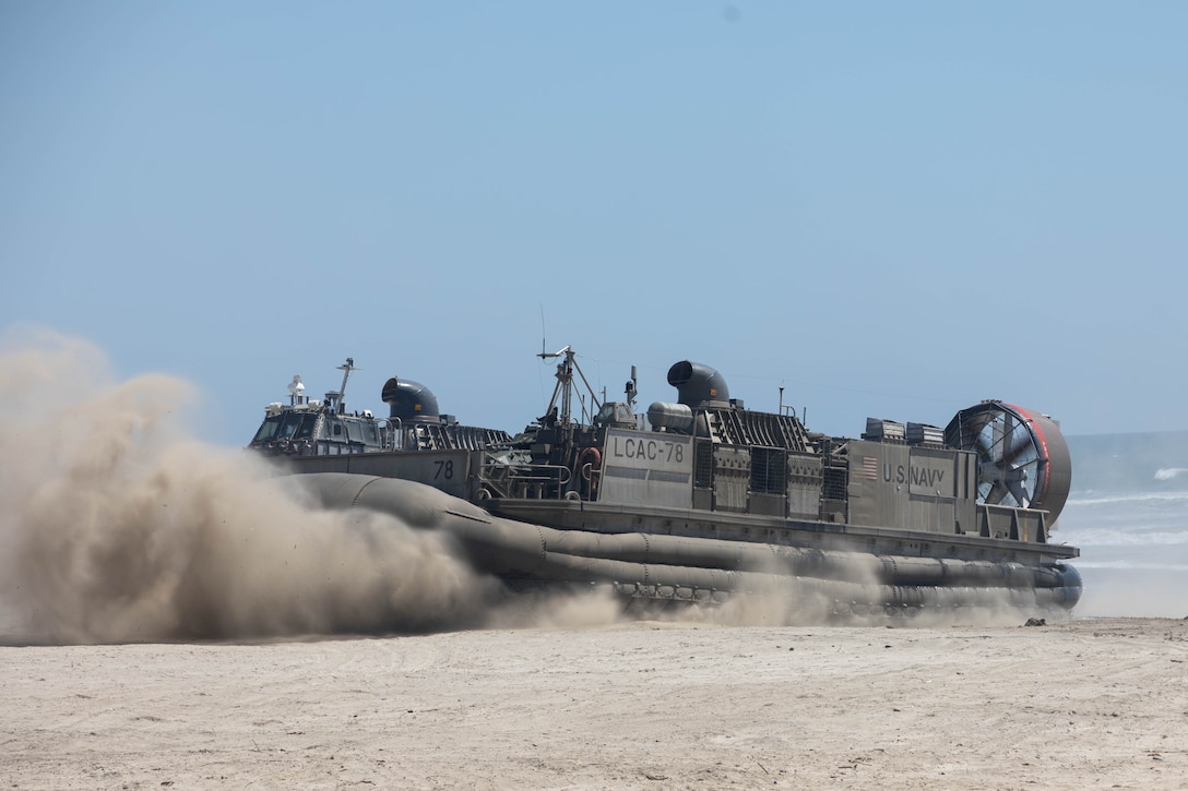A U.S. Navy landing craft, air cushion hovercraft with Assault Craft Unit 5 brings U.S. Marines with 1st Light Armored Reconnaissance Battalion, 1st Marine Division, ashore at Red Beach as part of a mobile reconnaissance battalion field exercise at Marine Corps Base Camp Pendleton, California, May 6, 2024. The exercise is designed to train Marines with 1st LAR Bn. to deploy as a mobile reconnaissance battalion, which will offer enhanced capabilities that exceed legacy LAR formations as a part of Force Design. (U.S. Marine Corps photo by Cpl. Keegan Jones)
