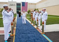 240514-N-MJ491-1048 VIRGINIA BEACH, Va. (May 14, 2024) Adm. Daryl Caudle, commander, U.S. Fleet Forces Command passes the side boys during a ribbon cutting ceremony for the Hefti Global Live, Virtual and Constructive (LVC) Operations Center at the Dam Neck Annex.  Hefti Global LVC Operations Center is named after Capt. John “Bag” Hefti, who was tragically killed in an auto accident in 2021.  Capt. Hefti led Sailors and operations in the Joint & Fleet Training Department for U.S. Fleet Forces.  Caudle officially named the Global LVC Operations Center after Capt. Hefti to honor his life and service. (U.S. Navy photo by Chief Mass Communication Specialist Matthew N. Jackson/Released)