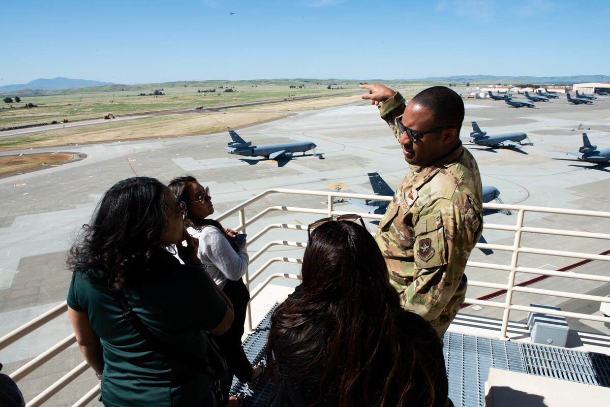 Airmen explains air traffic controller tower to distinguished visitors.