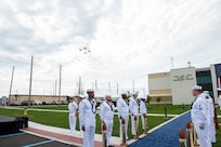 240514-N-MJ491-1048 VIRGINIA BEACH, Va. (May 14, 2024) Adm. Daryl Caudle, commander, U.S. Fleet Forces Command passes the side boys during a ribbon cutting ceremony for the Hefti Global Live, Virtual and Constructive (LVC) Operations Center at the Dam Neck Annex.  Hefti Global LVC Operations Center is named after Capt. John “Bag” Hefti, who was tragically killed in an auto accident in 2021.  Capt. Hefti led Sailors and operations in the Joint & Fleet Training Department for U.S. Fleet Forces.  Caudle officially named the Global LVC Operations Center after Capt. Hefti to honor his life and service. (U.S. Navy photo by Chief Mass Communication Specialist Matthew N. Jackson/Released)