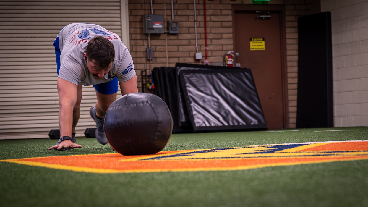 Capt. Christopher Moroz, 63rd Fighter Squadron F-35 Lightning II instructor pilot, pushes a medicine ball at the 56th Fighter Wing Tactical Integrated Training and Nutrition (TITAN) Arena, April 18, 2024, at Luke Air Force base, Arizona.