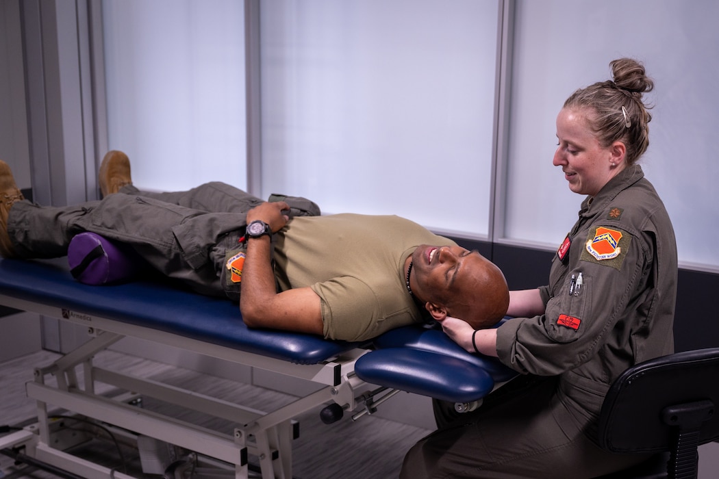 Maj. Michelle Jilek (right), 56th Training Squadron Human Performance Team commander, gives a physical adjustment to Capt. Rohan Papaly, 56th Training Squadron flight doctor, at the 56th Fighter Wing Tactical Integrated Training and Nutrition (TITAN) Arena, April 18, 2024, at Luke Air Force base, Arizona.