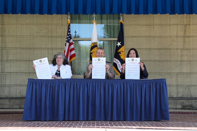 Army Gen. Daniel Hokanson, chief, National Guard Bureau, joins Cara Calvin-McFerren, mayor pro tem, West Liberty, Iowa and Jessica Chang, chief executive officer, Upwards, to sign a pilot child care intergovernmental support agreement at the Pentagon in Arlington, Virginia, May 13, 2024. The initiative helps Army National Guard Soldiers with community-based child care on drill weekends.