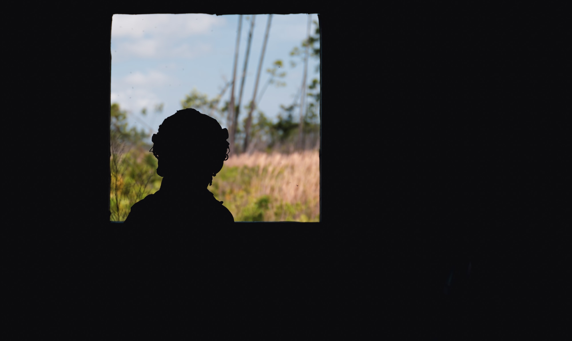 silhouette of man in front of window