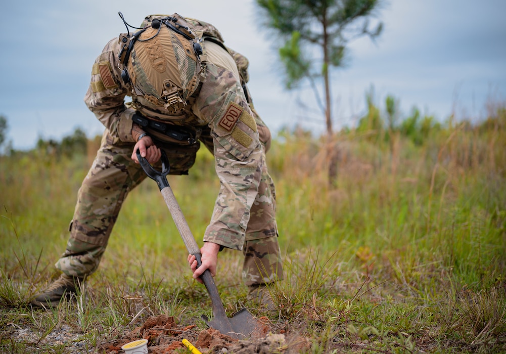 military man digs with shovel