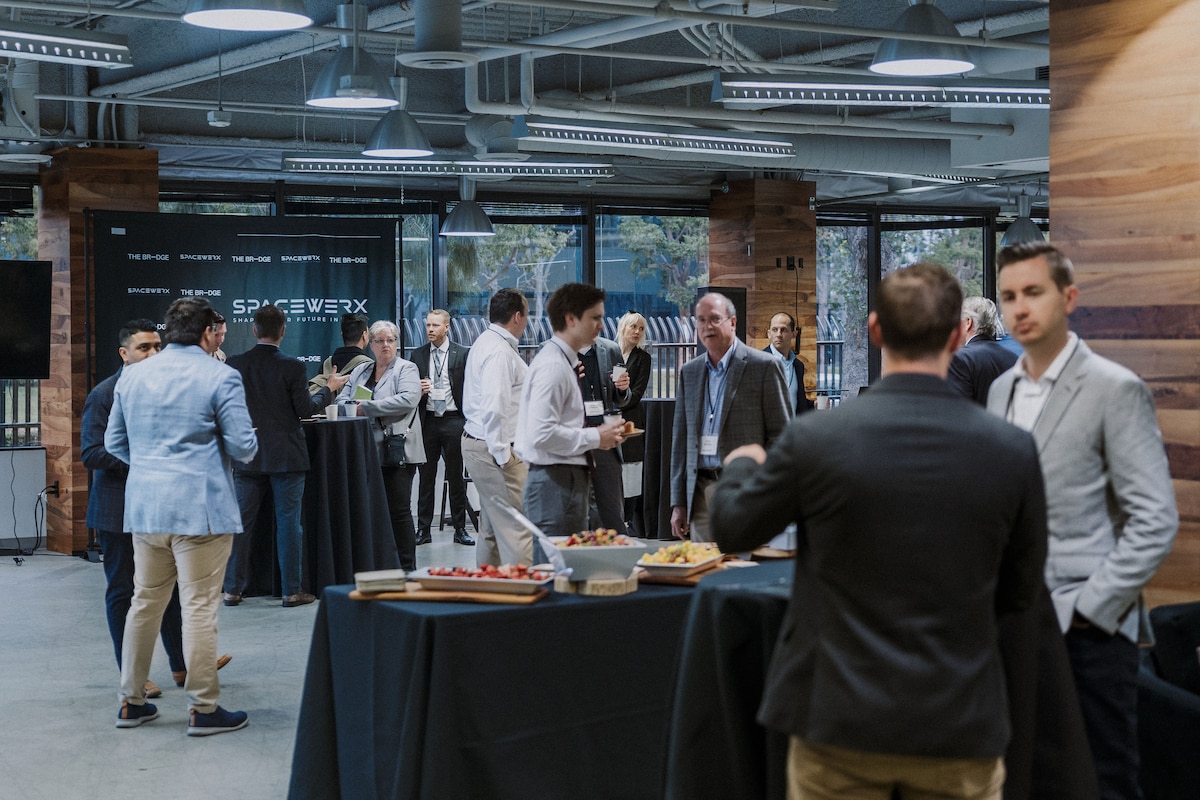 Innovate to Accelerate expo day attendees socialize during a break in El Segundo, California, April 25, 2024.