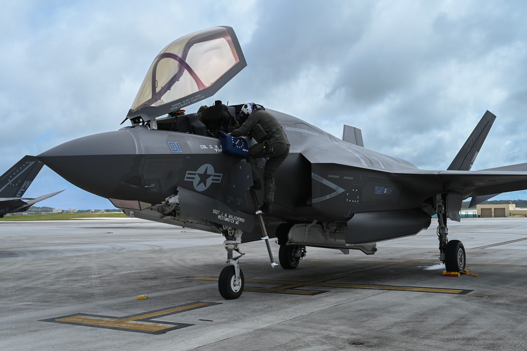 A U.S. Marine Corps F-35B Lightning II jet pilot climbs down the aircraft.