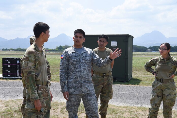 Photo of U.S. Air Force Airmen speaking with a Philippine Air Force officer