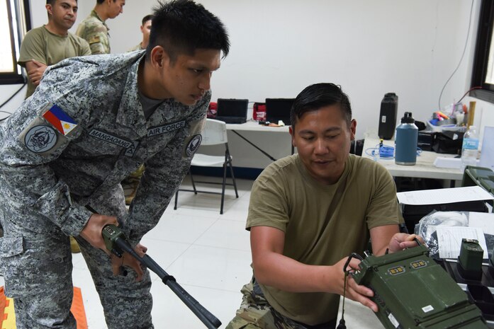 Photo of U.S. Air Force Airmen speaking with a Philippine Air Force officer