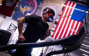 Phil Bailey, 56th Fighter Wing Human Performance Team strength coach demonstrates how to perform a V02Max test at the Tactical Integrated Training and Nutrition (TITAN) Arena, April 18, 2024, at Luke Air Force base, Arizona.