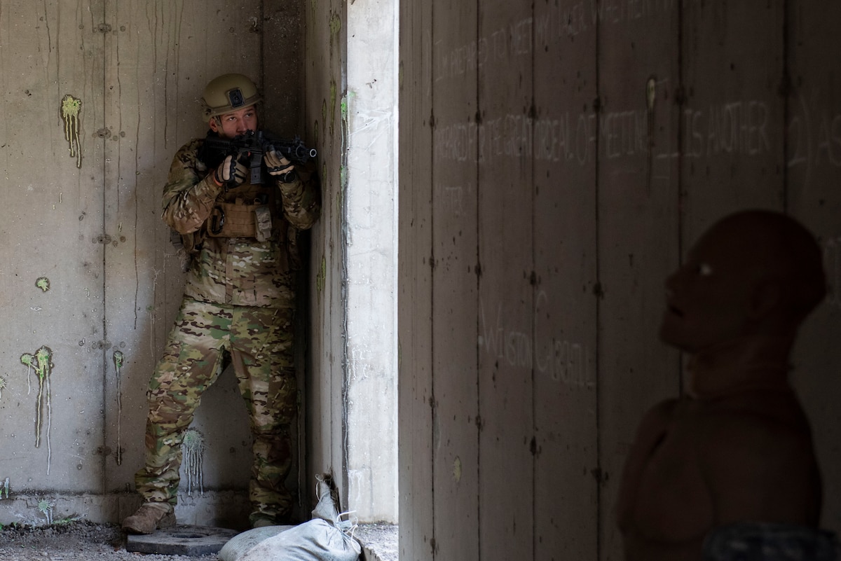 Photo of Airman securing a building