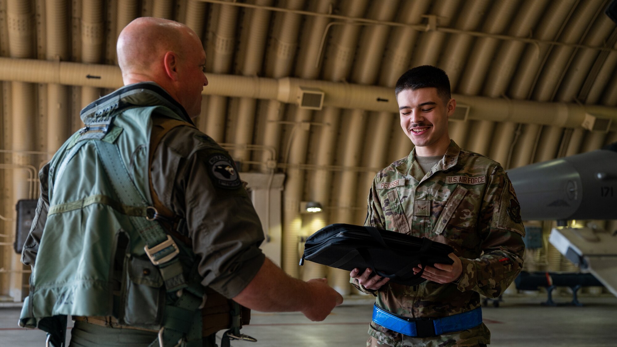 Airman First Class Andrew Petefish, right, 35th Fighter Generation Squadron dedicated crew chief, and Col. Matthew Gaetke, 8th Fighter Wing commander, review maintenance on a F-16 Fighting Falcon before takeoff.