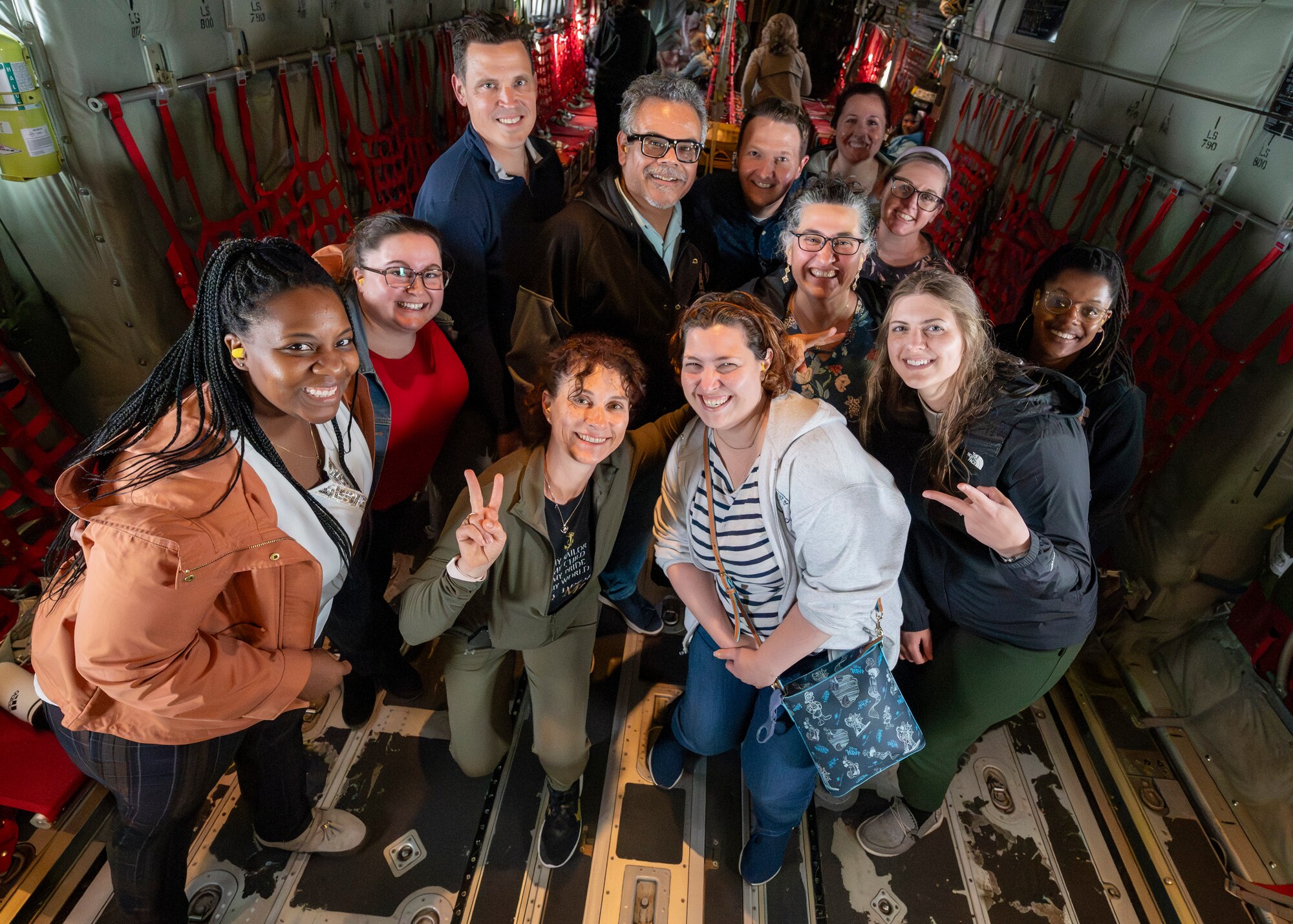 Teachers pose for a photo inside a C-130J Super Hercules.