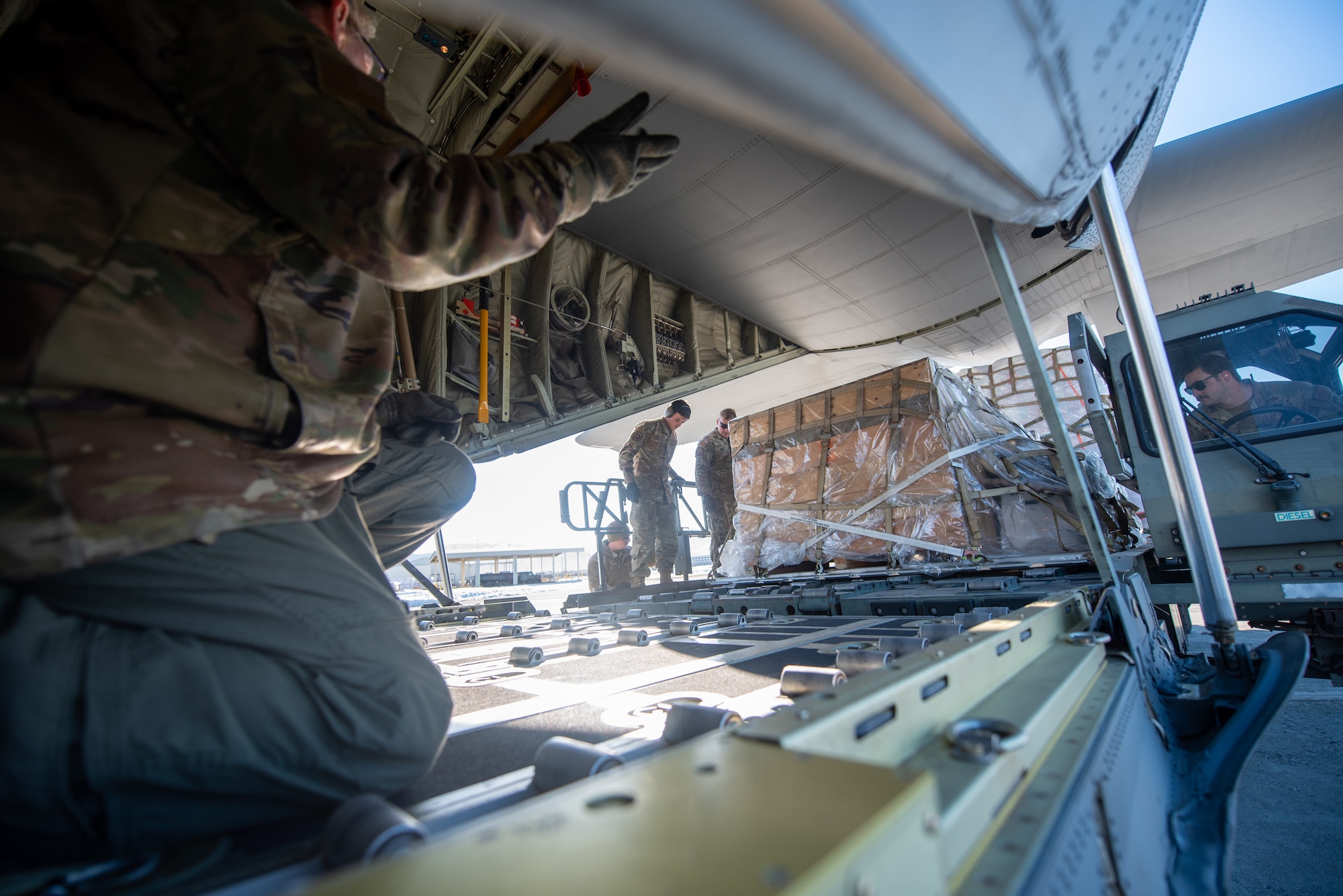 Airmen from the Kentucky Air National Guard’s 123rd Airlift Wing load cargo onto a Kentucky C-130J Super Hercules aircraft prior to departure from Joint Base Elmendorf-Richardson, Alaska, on April 24, 2024. The air transportation specialists, all from the wing’s 123rd Logistics Readiness Squadron, also palletized the cargo, which consists of building materials being shipped to Alaska’s North Slope. The items will be used to build homes for civilians as part of Innovative Readiness Training, a Defense Department program that provides service members with real-world deployment experience while offering lasting benefits to civilian populations. (U.S. Air National Guard photo by Phil Speck)