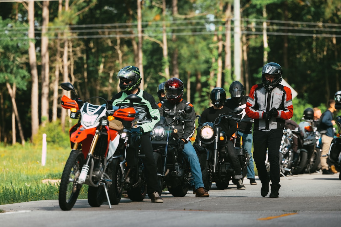 U.S. Marines, Sailors and civilians across 2d Marine Division (MARDIV) prepare to take off to the next station in the 2d MARDIV poker run on Camp Lejeune, North Carolina, May 2, 2024. 2d MARDIV conducted a group ride to promote safe riding, camaraderie, and mentorship through a series of physical and mental skills stations across Marine Corps Base Camp Lejeune and Marine Corps Air Station New River to raise awareness for the upcoming motorcycle riding season. (U.S. Marine Corps photo by Cpl. Alexis Sanchez)