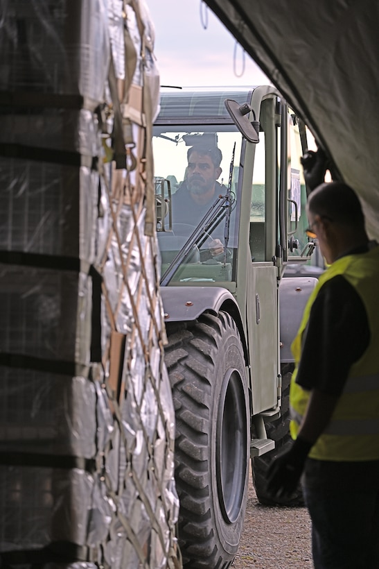 Worker uses construction equipment.