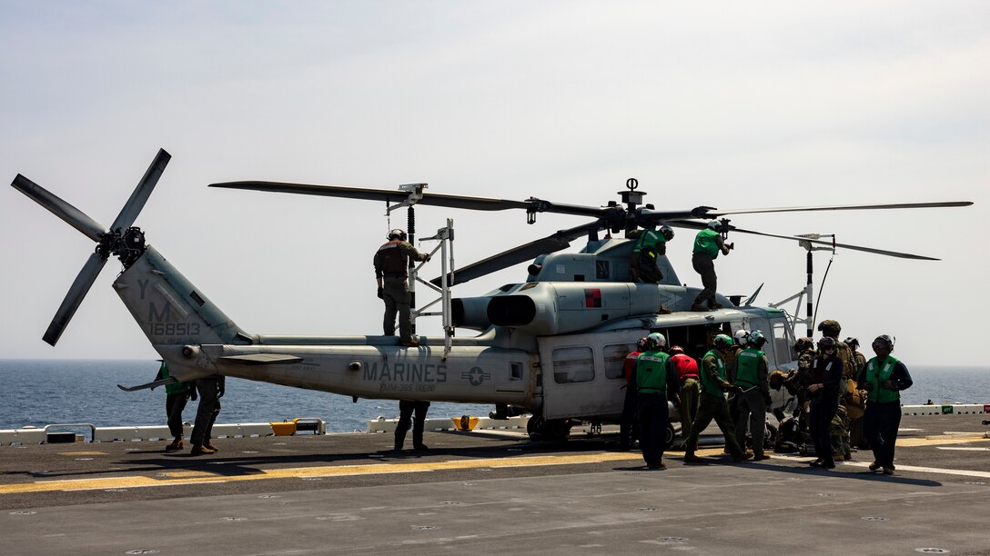 U.S. Marines and Sailors with the Wasp (WSP) Amphibious Ready Group (ARG)-24th Marine Expeditionary Unit (MEU) prepare a UH-1Y Venom with Marine Medium Tiltrotor Squadron 365 (Reinforced) for stowage on the flight deck aboard the amphibious assault ship USS Wasp (LHD 1) during Composite Training Unit Exercise (COMPTUEX) in the Atlantic Ocean, May 8, 2024. The WSP ARG-24th MEU is conducting COMPTUEX, their final at-sea certification exercise under the evaluation of Carrier Strike Group 4 and Expeditionary Operations Training Group. Throughout COMPTUEX, the WSP ARG-24th MEU is evaluated across a spectrum of scenarios that determine their readiness to deploy. (U.S. Marine Corps photo by Lance Cpl. John Allen)