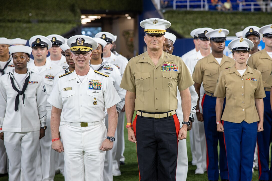 U.S. Navy Adm. David Caudle (left), commander of U.S. Fleet Forces Command, and U.S. Marine Corps Lt. Gen. Leonard Anderson IV (right), Commander of U.S. Marine Corps Forces, South, pose for a photo with Marines and Sailors following a reenlistment ceremony at a Miami Marlins game as part of Fleet Week Miami, May 10, 2024. Fleet Weeks are a tradition of the U.S. Navy, Marine Corps, and Coast Guard, where major U.S. cities host Marines, Sailors, and Coast Guardsmen for one week of community-wide events. Fleet Week Miami, in its first year, is an opportunity for residents and visitors to meet with servicemembers, foster community relationships, and view the latest capabilities of today's maritime services. 

(U.S. Marine Corps photo by Staff Sgt. Brett Norman)