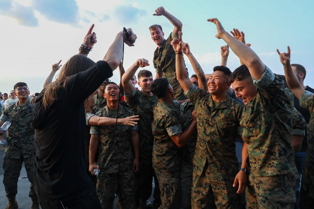 U.S. Marines and Sailors attend a Vetted concert hosted by the United Services Organizations (USO) during Fleet Week Miami aboard the amphibious assault ship USS Bataan (LHD 5) on May 11, 2024. Fleet Weeks are a tradition of the U.S. Navy, Marines Corps, and Coast guard where major U.S. cities host Marines, Sailors, and Coast Guardsmen for one week of community-wide events.  Fleet week Miami, in its first year, is an opportunity for residents and visitors to meet with service members, foster community relationships, and view the latest capabilities of today’s maritime services. (U.S. Marine Corps photo by Lance Cpl. Grace Stover)