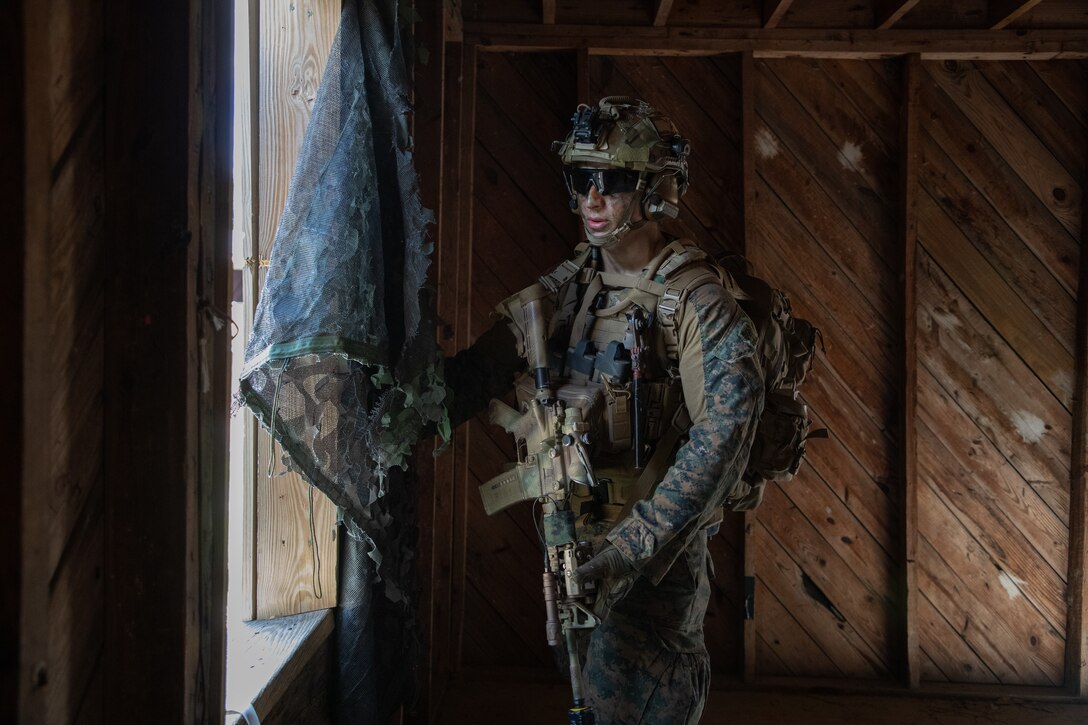 A U.S. Marine with Battalion Landing Team 1/8, 24th Marine Expeditionary Unit (MEU), conducts a raid as part of an amphibious assault mission during Composite Training Unit Exercise (COMPTUEX) on Camp Lejeune, North Carolina, May 11, 2024. The Wasp (WSP) Amphibious Ready Group (ARG)-24th MEU is conducting COMPTUEX, their final at-sea, certification exercise under the evaluation of Carrier Strike Group 4 and Expeditionary Operations Training Group. Throughout COMPTUEX, the WSP ARG-24th MEU is evaluated across a spectrum of scenarios that determine their readiness to deploy. (U.S. Marine Corps photo by Cpl. Aydan Millette)