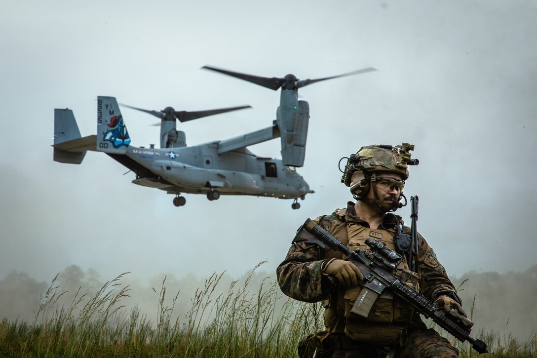 A U.S. Marine with Battalion Landing Team 1/8, 24th Marine Expeditionary Unit (MEU), provides security as a MV-22B Osprey with Marine Medium Tiltrotor Squadron 365 (Reinforced), 24th MEU lands during a tactical recovery of aircraft and personnel exercise as part of Composite Training Unit Exercise (COMPTUEX) on Stone Bay, Marine Corps Base Camp Lejeune, North Carolina, May 9, 2024. The Wasp (WSP) Amphibious Ready Group (ARG)-24th MEU is conducting COMPTUEX, their final at-sea, certification exercise under the evaluation of Carrier Strike Group 4 and Expeditionary Operations Training Group. Throughout COMPTUEX, the WSP ARG-24th MEU is evaluated across a spectrum of scenarios that determine their readiness to deploy. (U.S. Marine Corps photo by Cpl. Aydan Millette)