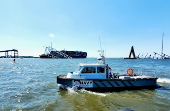 A SUPSALV harbor boat secures the area around the Francis Scott Key Bridge and the M/V Dali cargo vessel before a controlled demolition.