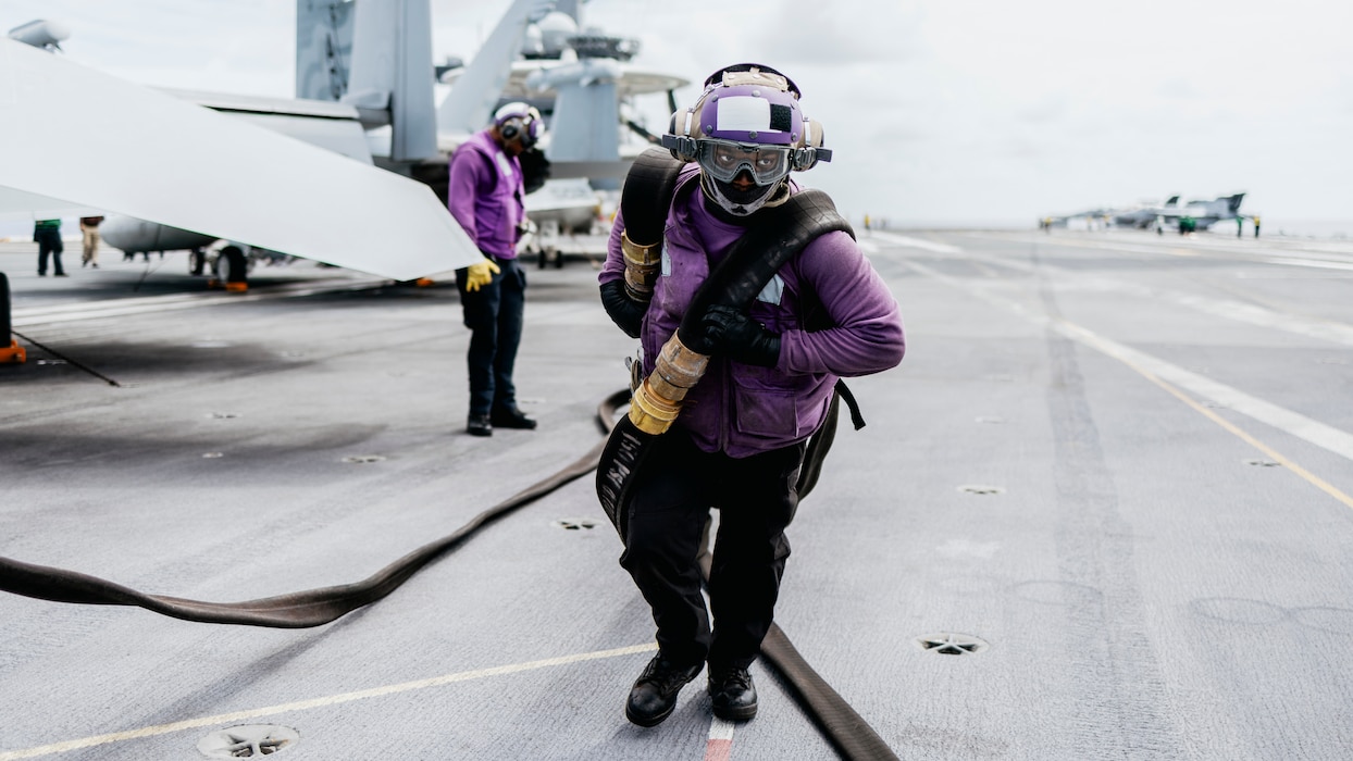 ABFAN Davion Thompson pulls fuel hoses aboard USS George Washington (CVN 73) in the Atlantic Ocean.