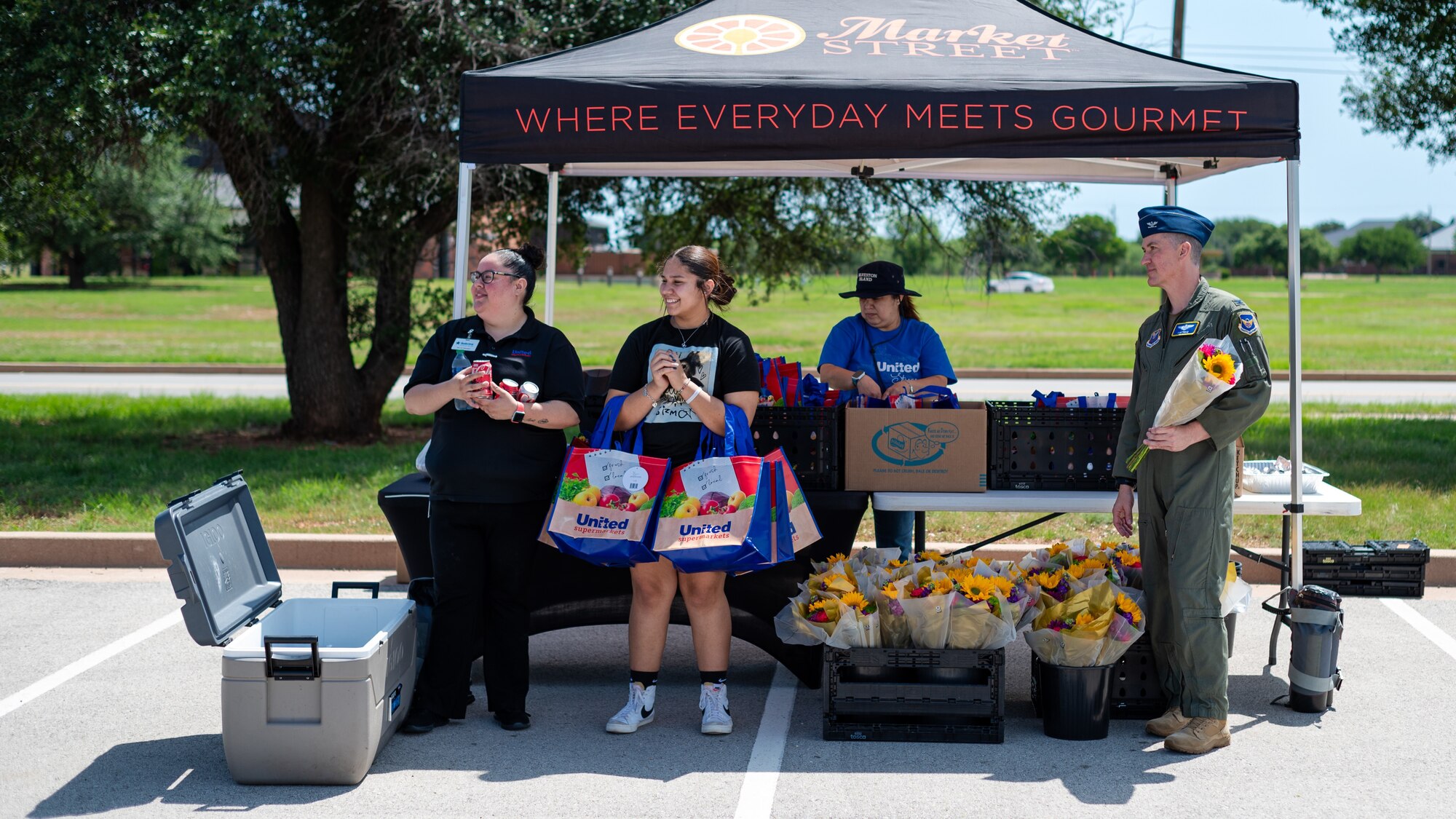 Volunteers wait to hand out gifts during the Military Spouse Appreciation Day event at Dyess Air Force Base, Texas, May 10, 2024. Volunteers from across the base dedicated their time to make stands, greet spouses and give gifts. The Department of Defense honors nearly one million military spouses worldwide for their service and sacrifice on this special day. (U.S. Air Force photo by Airman 1st Class Jade M. Caldwell)