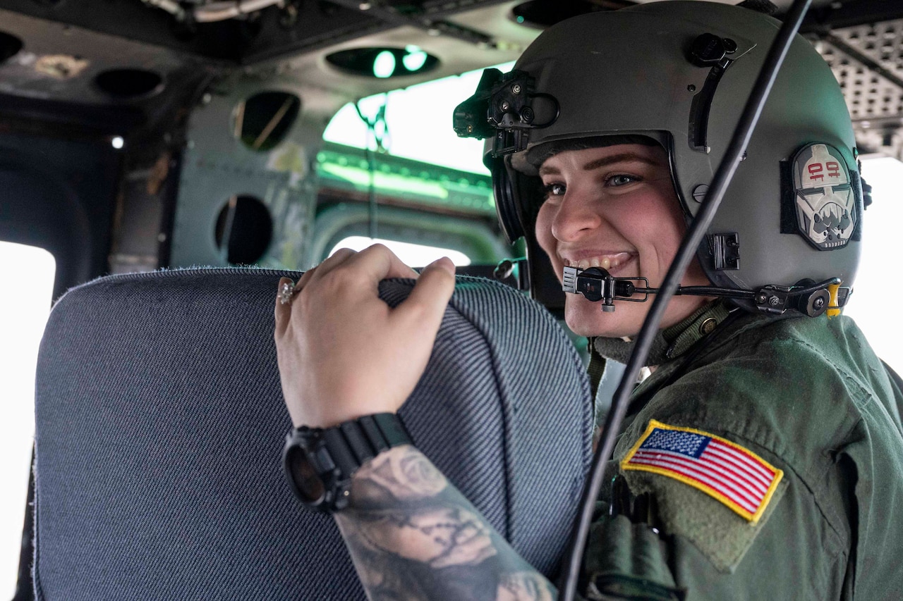 An airman wearing a helmet smiles.