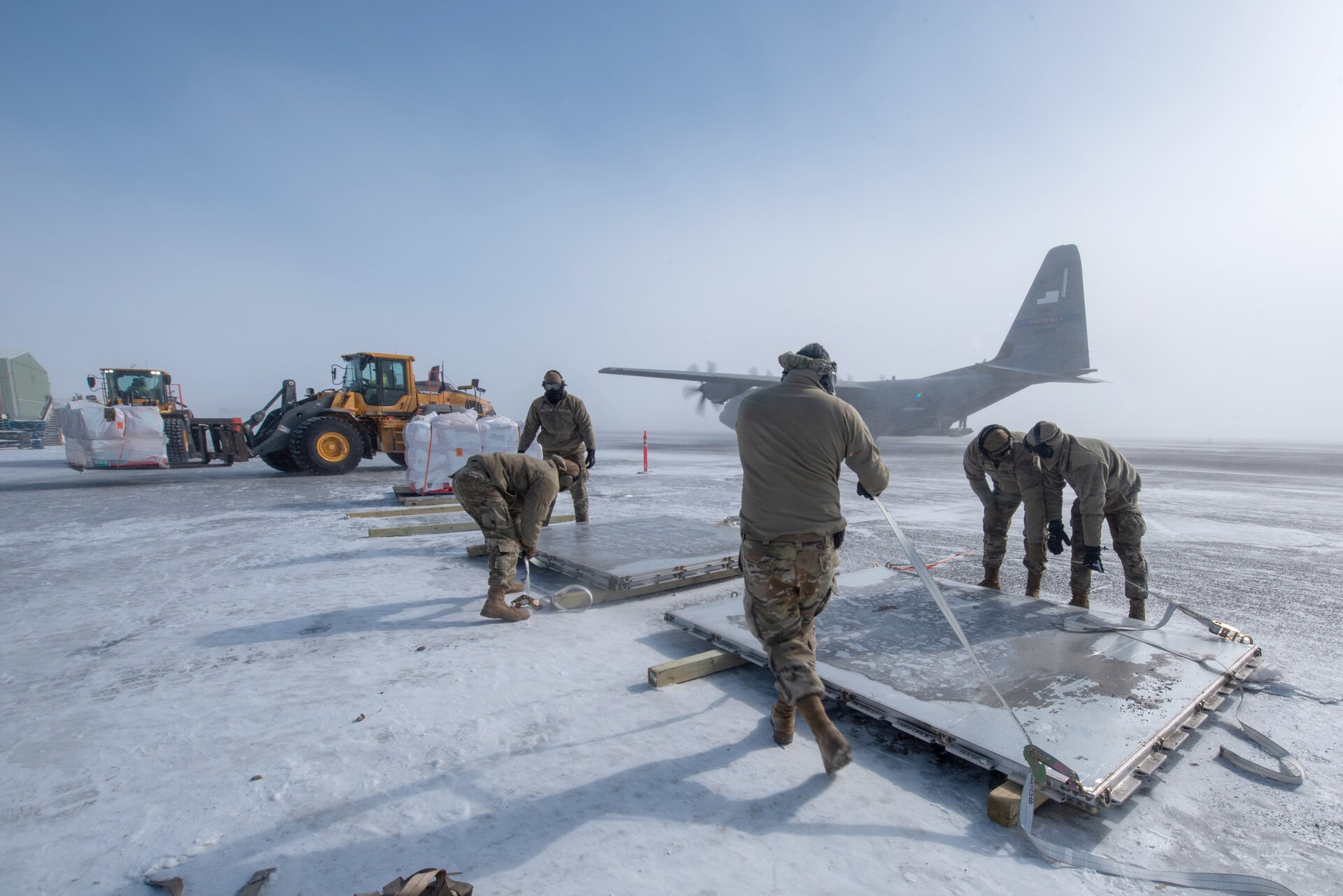 Airmen from the Kentucky Air National Guard’s 123rd Airlift Wing unload pallets of cargo under blizzard conditions during an engine-running offload from a Kentucky C-130J Super Hercules aircraft in Deadhorse, Alaska, on April 26, 2024. The cargo consists of construction materials to build homes for civilians as part of Innovative Readiness Training, a Defense Department program that provides service members with real-world deployment experience while offering lasting benefits to civilian populations. (U.S. Air National Guard photo by Phil Speck)