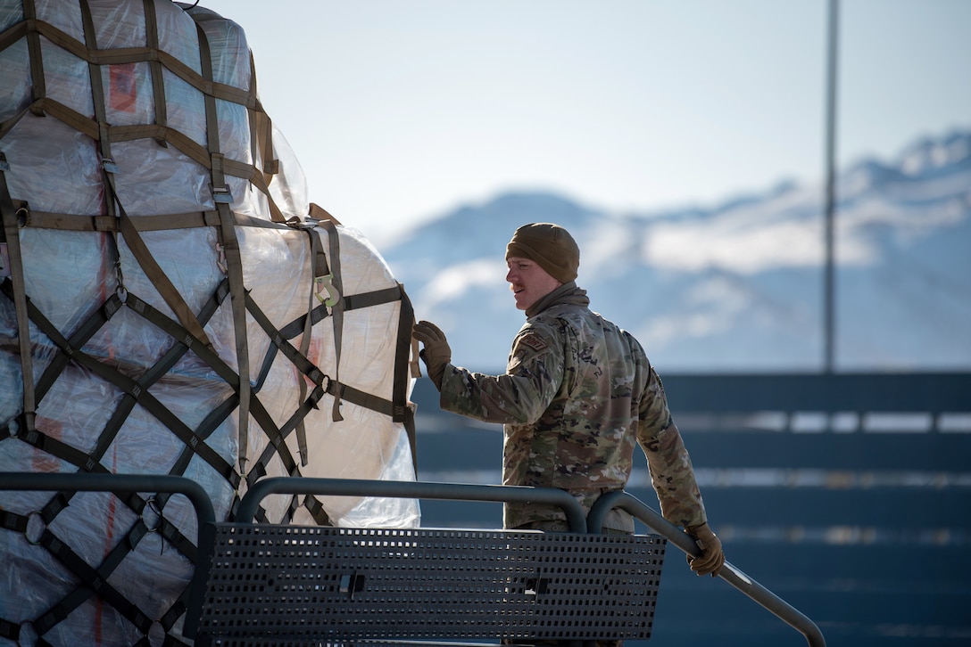 Staff Sgt. Alec Moser, an air transportation specialist from the Kentucky Air National Guard’s 123rd Logistics Readiness Squadron, loads cargo onto a C-130J Super Hercules aircraft from the 123rd Airlift Wing prior to departure from Joint Base Elmendorf-Richardson, Alaska, on April 24, 2024. Airmen from the squadron also palletized the cargo, which consists of building materials being shipped to Alaska’s North Slope. The items will be used to build homes for civilians as part of Innovative Readiness Training, a Defense Department program that provides service members with real-world deployment experience while offering lasting benefits to civilian populations. (U.S. Air National Guard photo by Phil Speck)