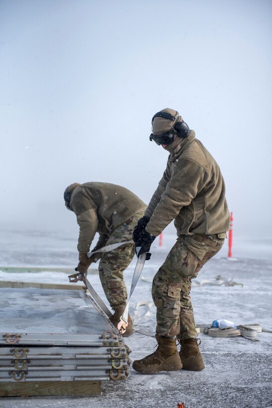 Airmen from the Kentucky Air National Guard’s 123rd Logistics Readiness Squadron secure cargo pallets after offloading construction supplies from a Kentucky C-130J Super Hercules aircraft under blizzard conditions in Deadhorse, Alaska, on April 26, 2024. The materials, which will be used to build homes for civilians, were airlifted as part of Innovative Readiness Training, a Defense Department program that provides service members with real-world deployment experience while offering lasting benefits to civilian populations. (U.S. Air National Guard photo by Airman 1st Class Annaliese Billings)